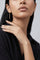 Model wearing a black high neck top and Earrings in 18k White gold with white and champagne diamonds