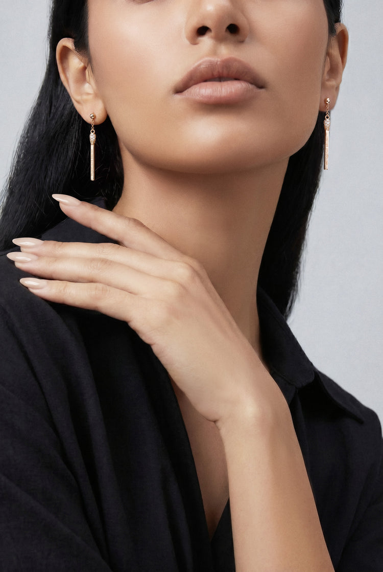 Model wearing a black high neck top and Earrings in 18k White gold with white and champagne diamonds