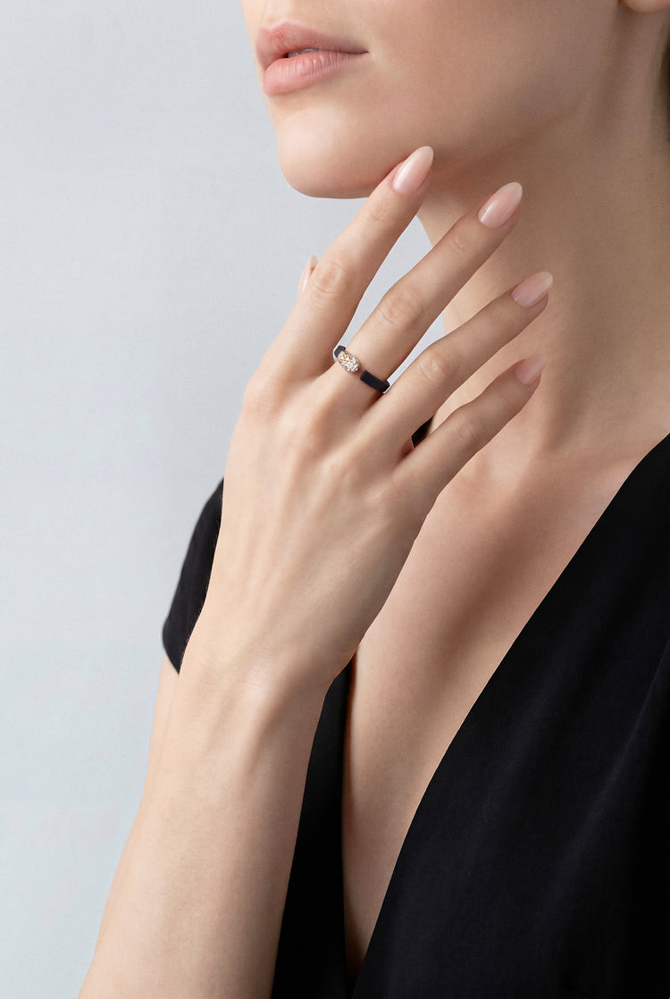 Model wearing a Ring in 18k Rose Gold an Black Titanium with White and Champagne Diamonds with a black shirt.