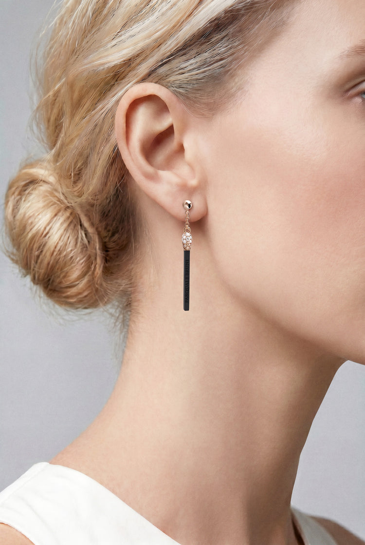 Model wearing a white top and Earrings in 18k Rose Gold and Black Titanium with White and Champagne Diamonds.